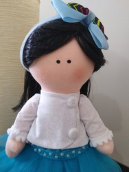 Cloth doll with black hair and dress