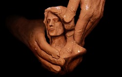 Hands of God creating man from clay. Biblical concept religion theme.
