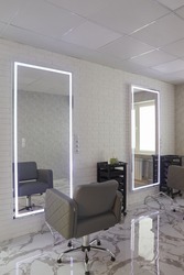 barber chair and mirrors in an elite beauty salon, cosmetologist's office interior