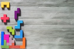 The concept of logical thinking. Geometric shapes on a wooden background. Tetris toy wooden blocks.
