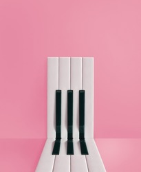 Minimal aesthetic composition of piano keys arranged in an abstract, rectangular shape on an isolated pastel pink background. Music creative card. Door or entrance concept.