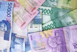 Indonesian rupiah note. Indonesian Rupiah the official currency of Indonesia. Business concept, Pink Background. Uang Rupiah Indonesia. Bank Indonesia. Flat lay, high angle view. top view.