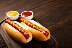 Hot dog with ketchup and yellow mustard.