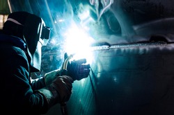 Welder worker doing aluminum welding