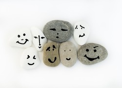 Emotion management concept, stones with painted faces symbolize different emotions. We are all different, but all together. Emotional intelligence, role model. Solidarity, tolerance, teamwork.