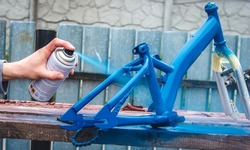father paints a bicycle for a child. selective focus