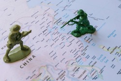 China and Taiwan conflict or war concept photo with figure soldiers on the map. Chinese and Taiwanese war. Selective focus.