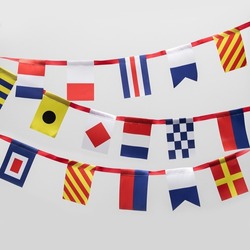 Garland of international maritime signal flags on white background
