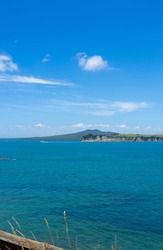 View across Hauraki Gulf from Motuihe Island to volcanic cone of Rangitoto Island New Zealand.