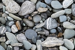 River stones in typical random pattern and type in New Zealand.