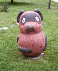 Beautiful sculpture of Winnie the Pooh in the Altai Mountains in Russia in the summer