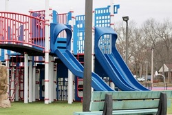 A large playground with a pirate theme. There are sails, a pirates only sign, and toy cannons.