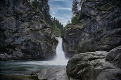 long exposure waterfall between a rockformation