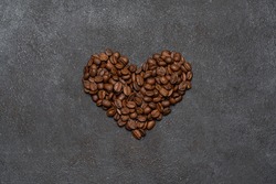 Background or wallpapper - heart made of coffee beans on congrete