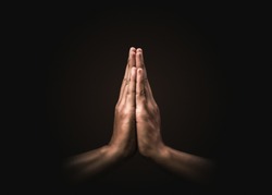 Praying hands with faith in religion and belief in God on dark background. Power of hope or love and devotion. Namaste or Namaskar hands gesture. Prayer position.