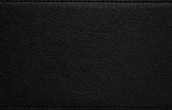 Black leather texture. Dark synthetic material background. Detail of rough surface.
