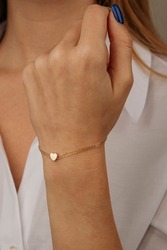 women's gold bracelet on the girl's hand, women's accessories, jewelry, gold bracelet with stones, women's jewelry, a girl with a bracelet on her arm, a bracelet with stones