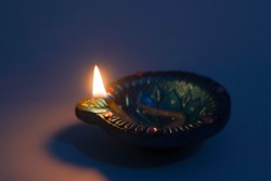 Diya lamp with fire. Traditional Divali festival. Close up.