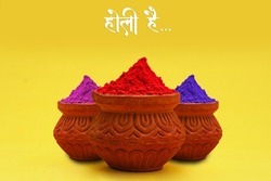 Indian festival Holi concept colour bowl with colorful background and writing holi Hai in marathi calligraphy.
