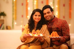 Young couple celebrating diwali with full of happiness