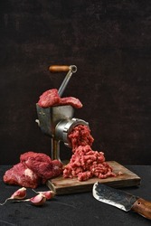 Making minced beef meat with oldfashioned meat grinder