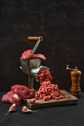 Making minced beef meat with oldfashioned meat grinder