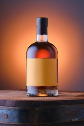 Blended malt scotch whisky on top of the barrel over blue orange gradient background