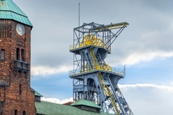 Mine shaft tower and historical clock tower in coal mine 'Wieczorek' in Katowice, Silesia, Poland. 