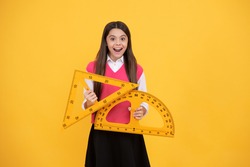 modern education concept. concept of education. measure the angle. child with triangle. amazed teen girl hold protractor ruler. back to school. algebra and geometry. kid study math. stem disciplines.
