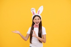 easter shopping sale. just having fun. ready for party. happy childhood. cheerful kid presenting product. happy easter holiday. funny child in rabbit ears. teenager girl in bow tie. bunny hunt.