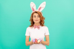 Easter bunny. happy easter. woman in rabbit ears and bow tie. time for fun. egg hunt. adorable lady looking funny. paschal spring holiday. redhead woman hold painted eggs. happy girl wear bunny ears.