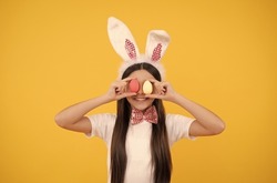 Pretty bunny. funny child in rabbit ears. smiling teenager girl in bow tie. bunny egg hunt.