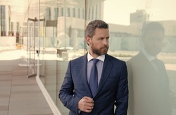 mature bearded man businessperson in businesslike formal suit outside the office, formalwear