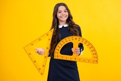 Schoolgirl in school uniform hold mathematics measure. Metric measurement. School equipment. Teenager student study stem disciplines.
