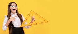 amazed child in school uniform and glasses hold mathematics triangle for measuring, trigonometry. Horizontal isolated poster of school girl student. Banner header portrait of schoolgirl copy space.