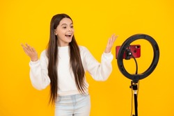 Teenager child recording video tutorial for social media with smart phone. Influencer teenager creating new content for blog while streaming online.