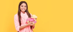 happy teen girl in home terry bathrobe with toy, happiness. Banner of child girl with toy, studio portrait, header with copy space.