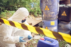 Asian scientist wear Chemical protection suit check danger chemical,working at dangerous zone