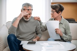 Stressed retired wife and husband manage family finances. Feeling desperate due debts, unpaid bills, lack of money to pay monthly loan or bank mortgage. Financial crisis, bankruptcy concept