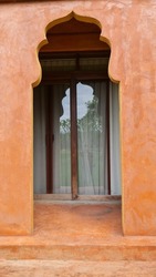 The orange-brown arched arch has a delicate notch above it. It is a symbol of a beautiful resort.