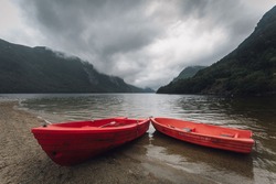 Red boats ashore a Fjord  