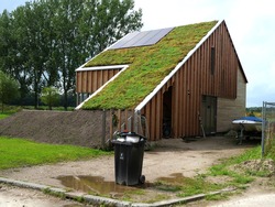 Energy neutral house with green living roof. The house has a wooden exterior made of natural material and is energy friendly. Thishouse has solar panels  and is build in the Netherlands.