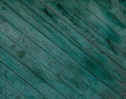dark wood texture. the background is old. blue-green painted, turquoise dark diagonal panels. 