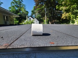 A roll of toilet paper isolated on a rooftop. The toilet paper roll is new, thick, and extra quilted.