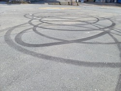 Rubber marks left in cement where vehicles were spinning in circles.