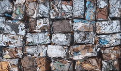 Scrap metal pressed into cubes for recycling, top view.