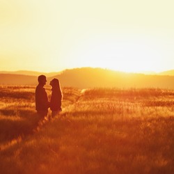 Couple in love have fun in beautiful morning wheat field.