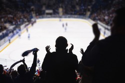 Fans support team in ice hockey stadium - happy people applause after winning goal..