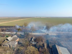 Burning of dry grass on the outskirts of the village