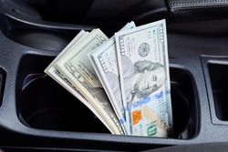 A wad of dollars inside the car. A wad of dollars inside the car.